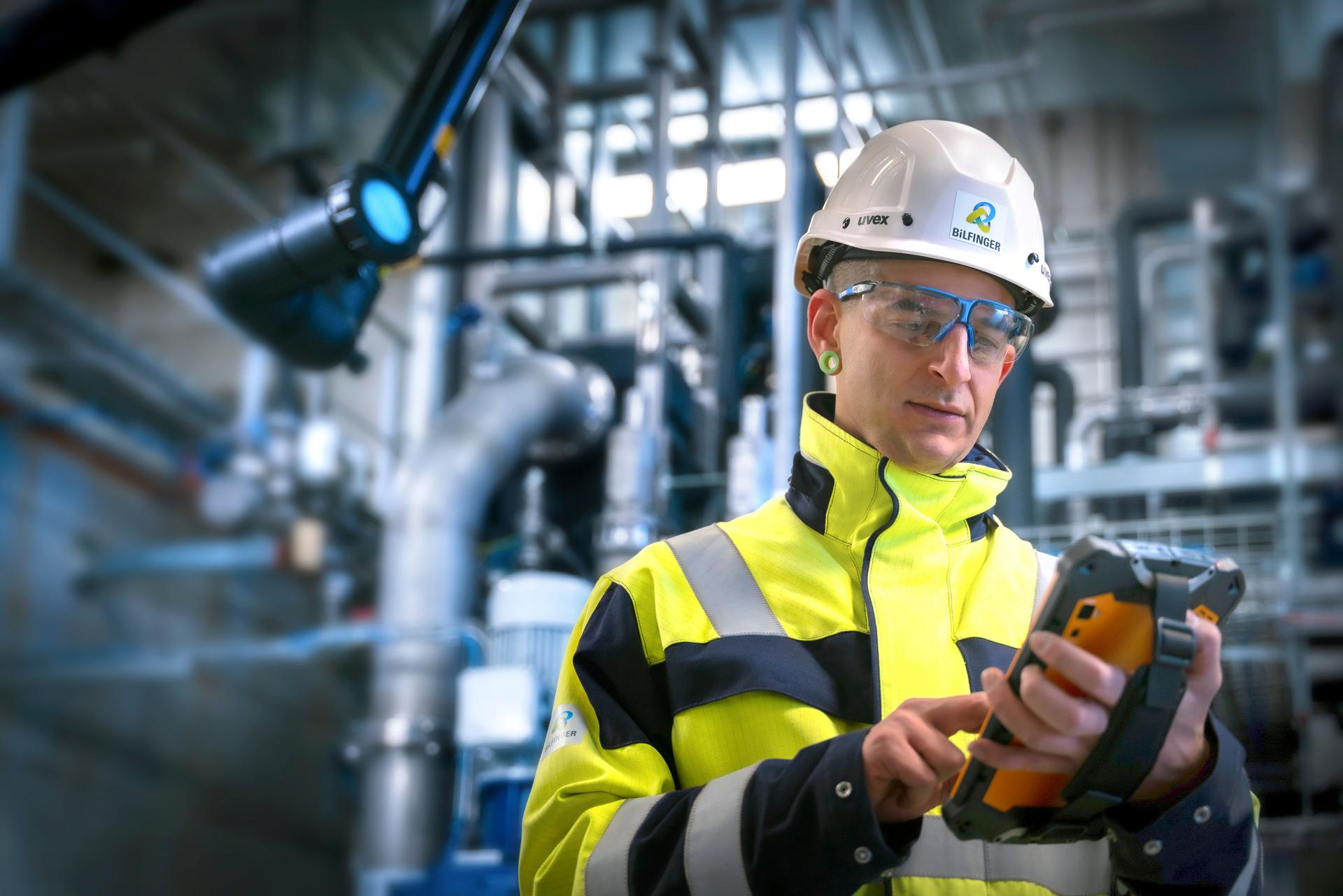 Employee looks intently at work tool