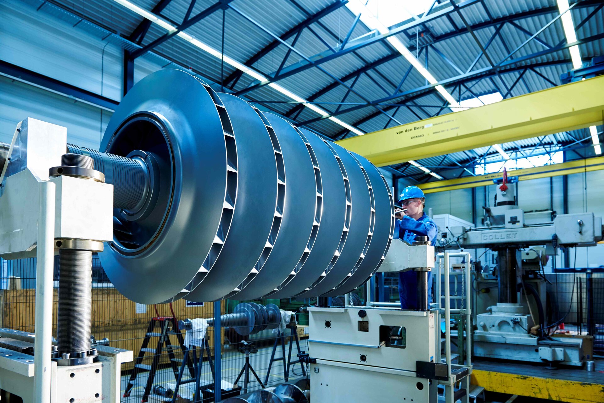 Professional turbine maintenance and servicing by experienced technicians A qualified technician performs routine maintenance and servicing on a high-performance industrial turbine to ensure its smooth operation and efficiency.