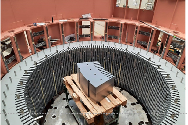 Interior view of an electrical machine casing featuring a centrally placed component surrounded by stator laminations.
